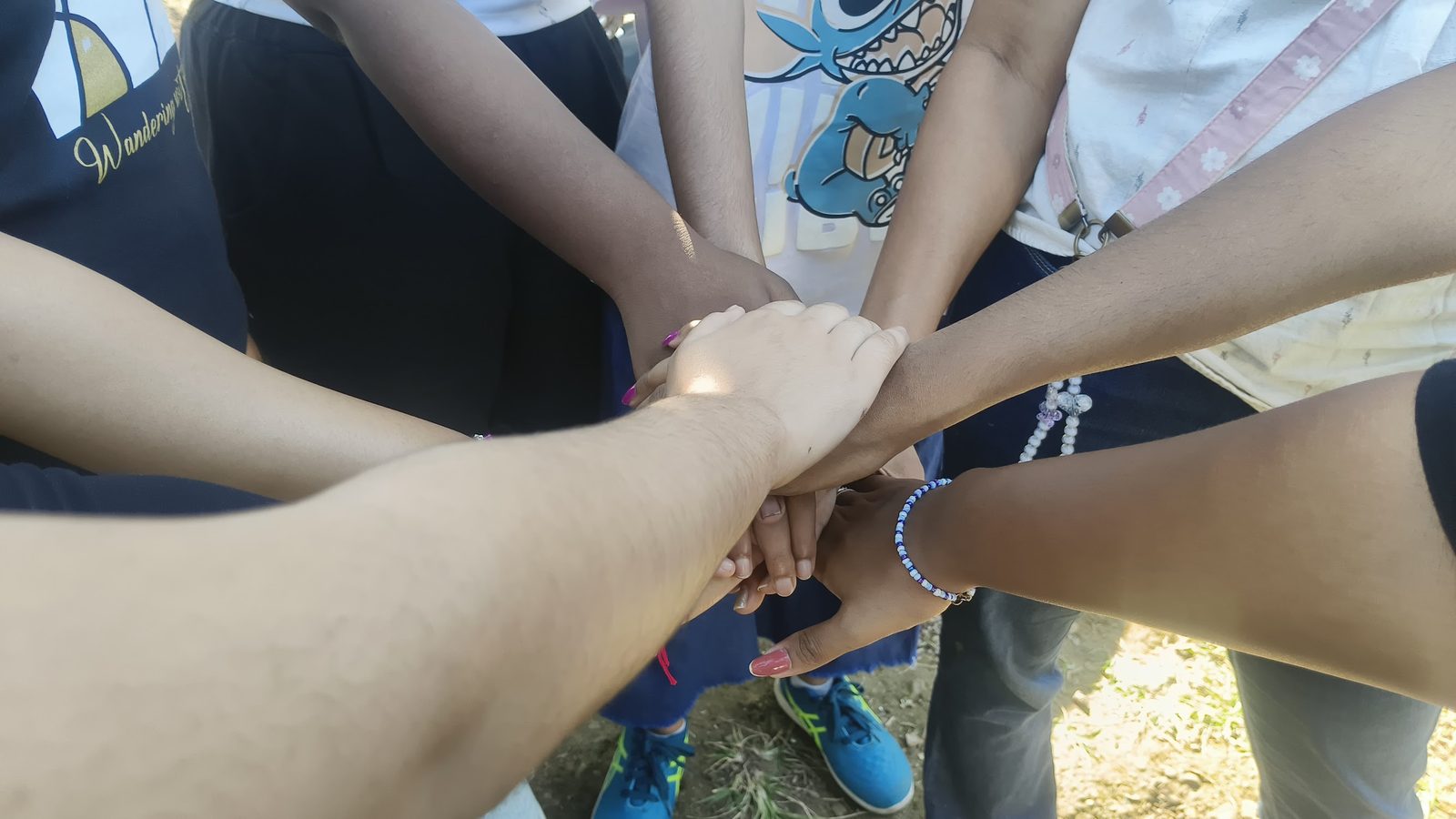 Campers stacking their hands together in a circle